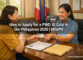 A Filipino woman receives her PWD ID card from a government staff member at an MSWDO office in the Philippines.