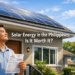A Filipino homeowner stands in front of his suburban house with solar panels installed on the rooftop, holding a Meralco electricity bill on a sunny day.