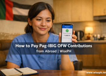A Filipino OFW nurse in scrubs checks her Pag-IBIG payment confirmation on her phone while sitting in an apartment abroad.