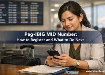 A Filipino woman completes her Pag-IBIG MID number registration on her phone at an airport departure gate before her flight abroad.